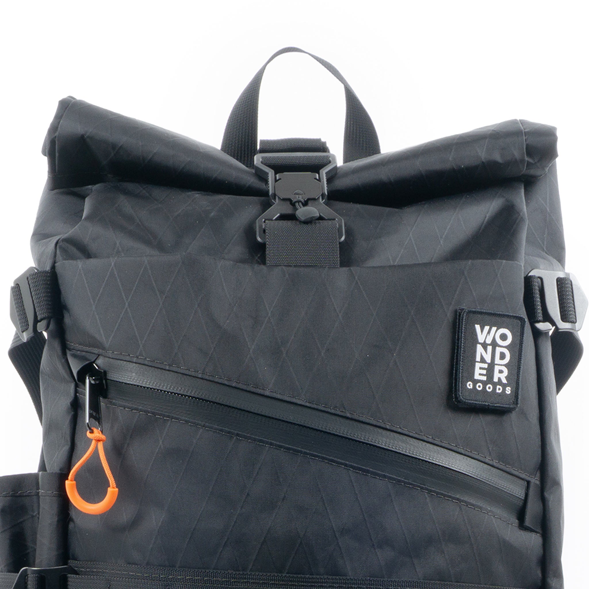 Wonder Goods black roll top backpack with a close up of the top magnetic buckle from Fidlock.