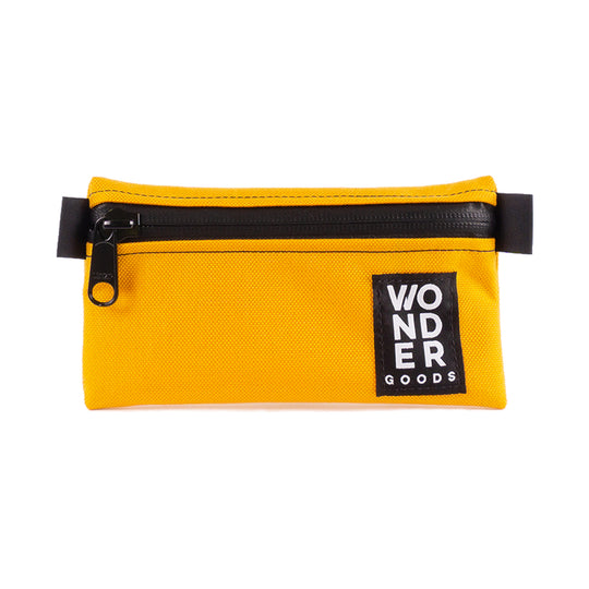 Small yellow zipper pouch for travel and adventure with a water-proof zipper.